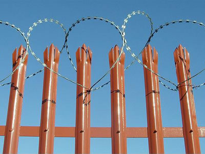 The orange PVC palisade fence with razor wire winding at the top, the fence is triple pointed head and D section pale.