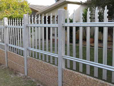 Triple & notched galvanized palisade fence on the wall, they serve as a security fence for private yard together.